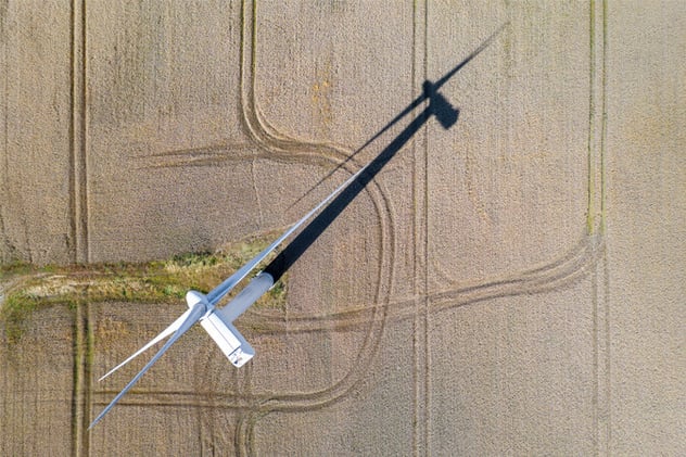 aerial-view-wind-turbine-brown-fields_675x450