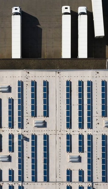 Aerial_View_of_Cargo_Containers_and_Distribution_Warehouse_with_Renewable_Energy_Plants-1-1